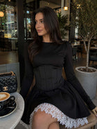 Female model wearing the Black Dress With Corset and white lace hem