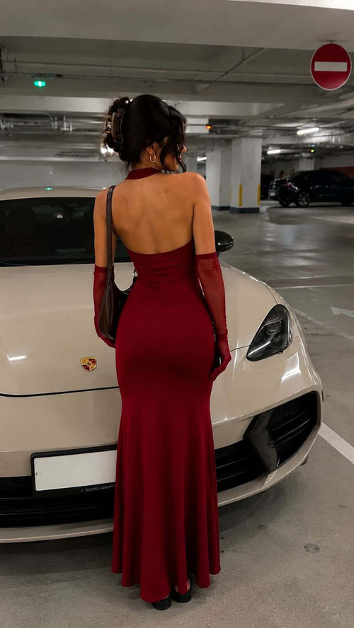 Back view of a female model wearing the Bordo Imperia halter maxi dress with an open back