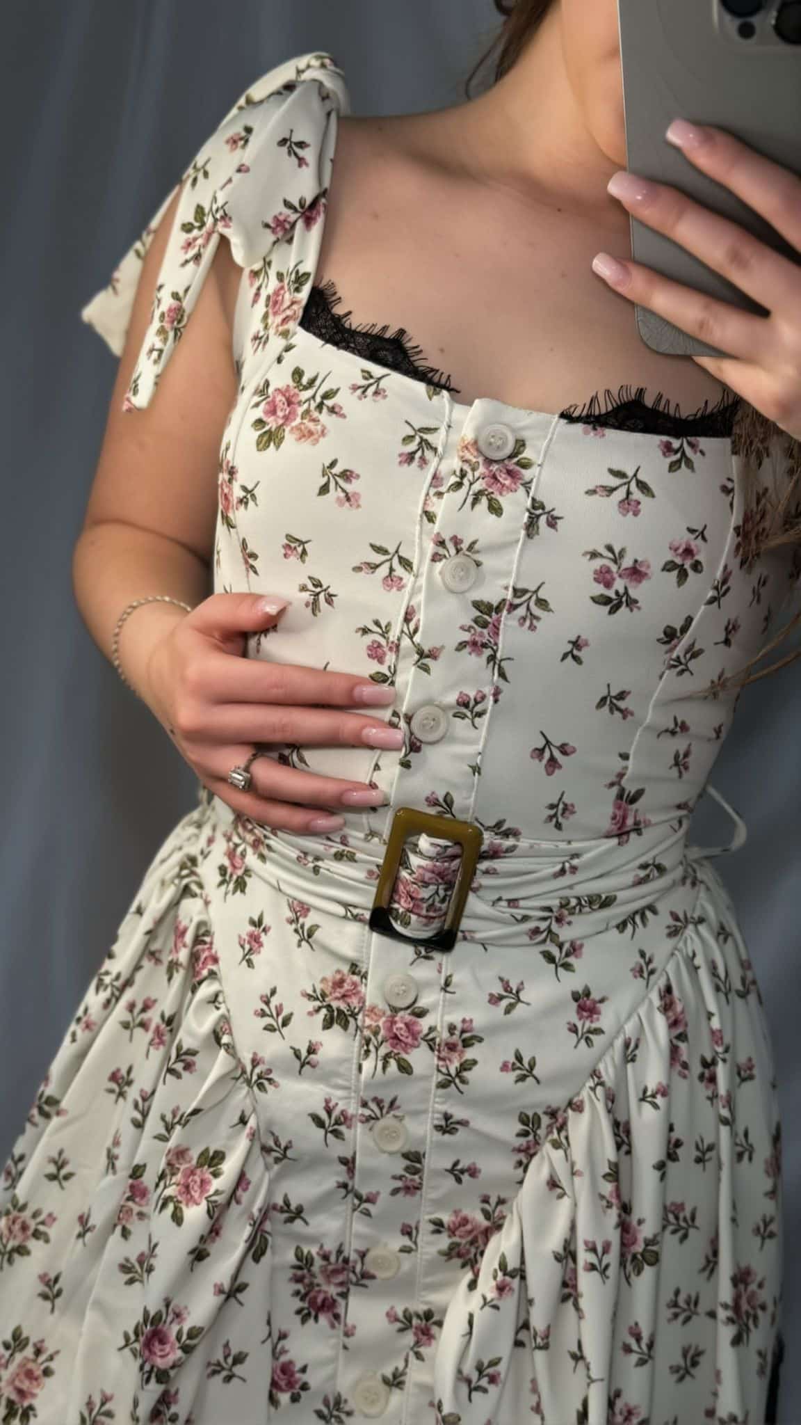 Close-up of the Floral Mini Lime Dress showing the floral print, front buttons, lace trim and belt