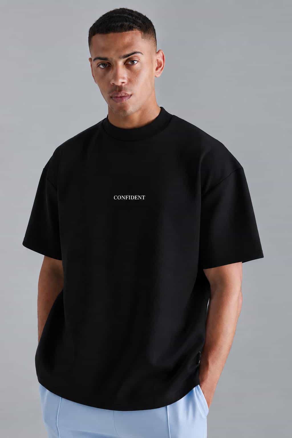 Male model wearing a black S&A Collection CONFIDENT oversized T-shirt
