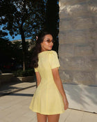 Back view of a female model wearing the Pastel Yellow Dress