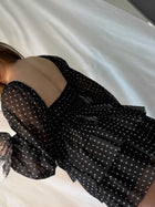 Close-up of the black Polka Dot Mini Dress showing sheer fabric, white dots and layered ruffles