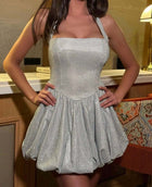 Close-up of the Silver Shimmer Dress showing its sparkling fabric, fitted bodice and bubble skirt