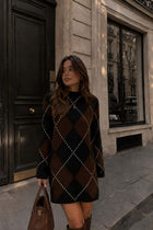 Female model wearing a brown and black argyle Sweater Dress with knee-high boots