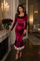 Female model wearing a burgundy Velvet Midi Dress with long sleeves and a layered ruffle hem
